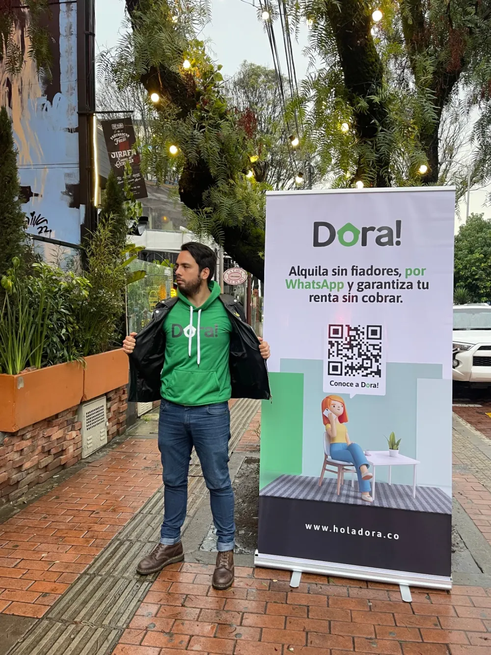 Federico next to a DORA banner in Bogotá